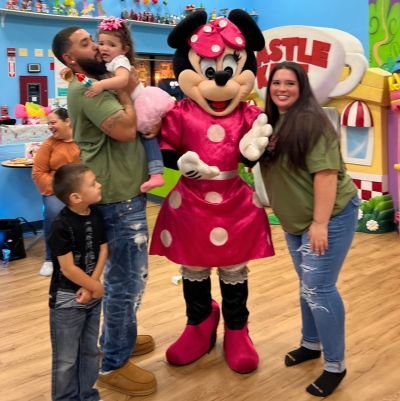 Family at kids party with Minnie Mouse Character 