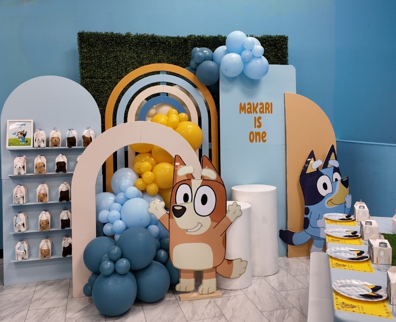 Bluey themed party setup at Kidz Kastle, a kids' birthday venue in Rhode Island with Bluey characters and balloons.